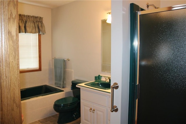 full bath featuring a tub, a shower with shower door, toilet, and vanity