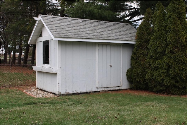 view of shed featuring fence