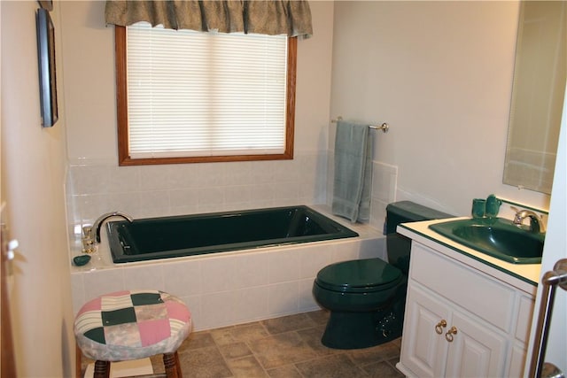 full bath featuring toilet, a garden tub, and vanity