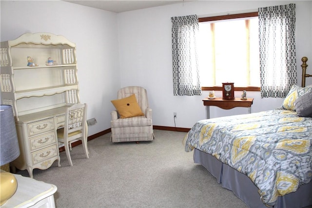 carpeted bedroom featuring baseboards