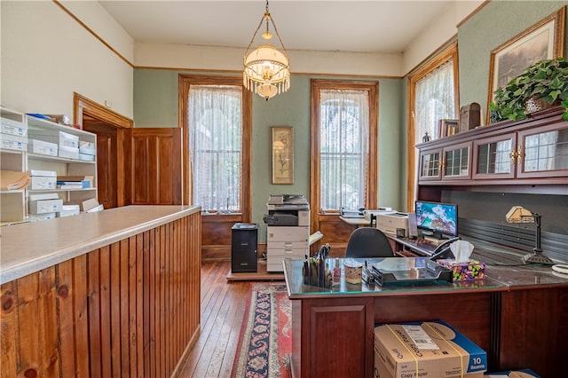 office featuring dark hardwood / wood-style flooring and a chandelier