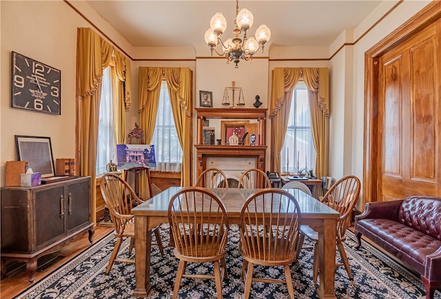 dining area featuring hardwood / wood-style flooring and a chandelier