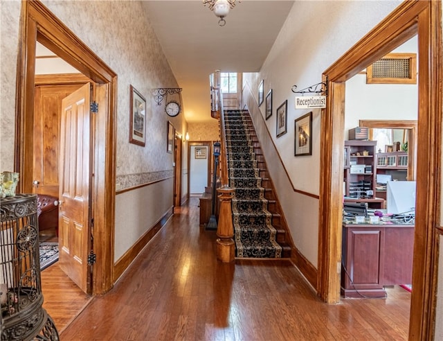 hall with hardwood / wood-style floors