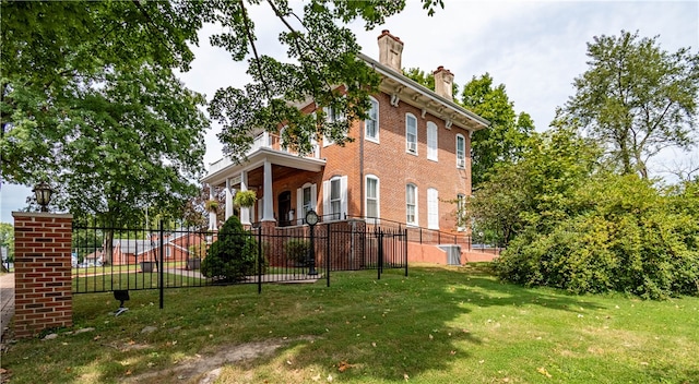 view of side of home with a yard