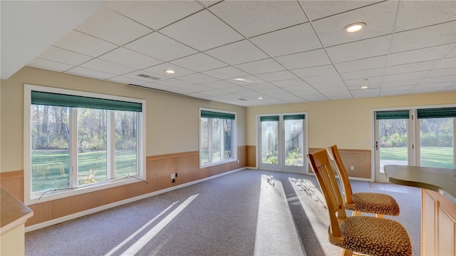 unfurnished dining area featuring a wainscoted wall, carpet, visible vents, and recessed lighting