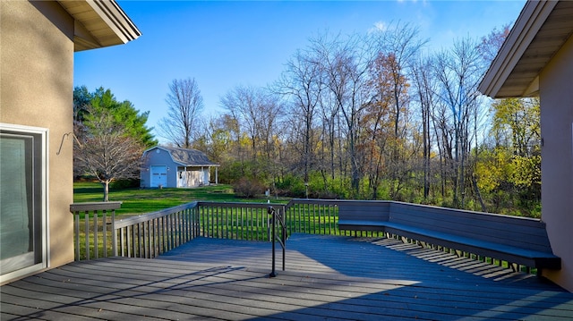 deck featuring a yard and an outdoor structure