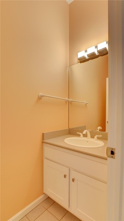 bathroom featuring tile patterned flooring, vanity, and baseboards