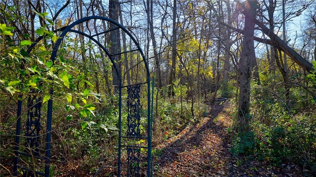 view of gate with a view of trees