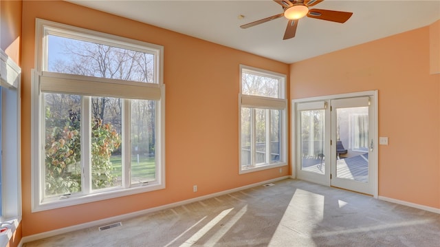 interior space featuring carpet, visible vents, ceiling fan, and baseboards