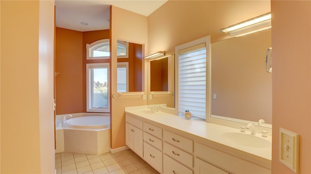 bathroom featuring tile patterned flooring, double vanity, a sink, and a bath