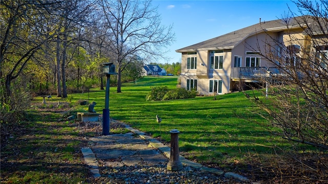 view of home's community featuring a deck and a lawn