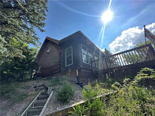 315 W Autumn Dr, Oakwood, IL 61858 - view of property exterior featuring log siding and a garden