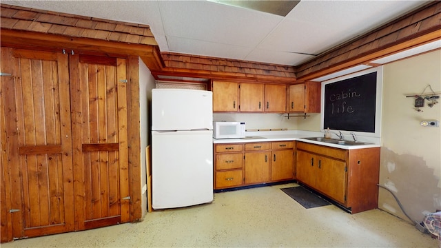 315 W Autumn Dr, Oakwood, IL 61858 - kitchen with white appliances, light countertops, brown cabinets, and wood walls