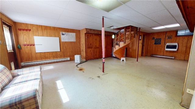 315 W Autumn Dr, Oakwood, IL 61858 - below grade area with a baseboard radiator, wooden walls, heating unit, stairs, and a drop ceiling