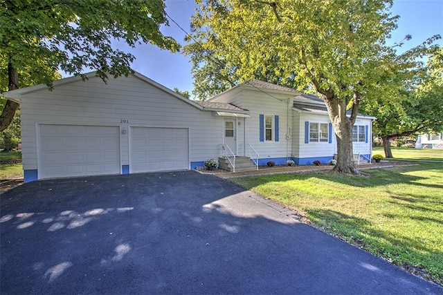 ranch-style home with a front yard and a garage