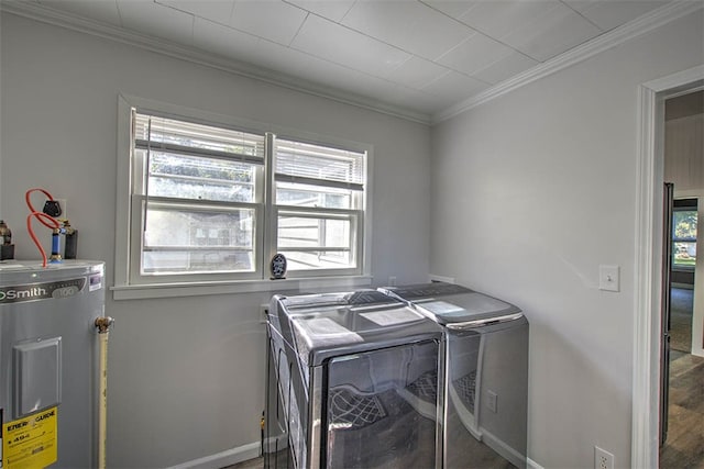 washroom featuring a healthy amount of sunlight, electric water heater, crown molding, and washer and dryer