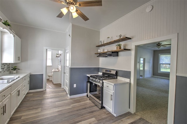 kitchen featuring white cabinets, light wood-type flooring, and stainless steel gas range