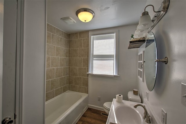 full bathroom with vanity, toilet, wood-type flooring, and tiled shower / bath