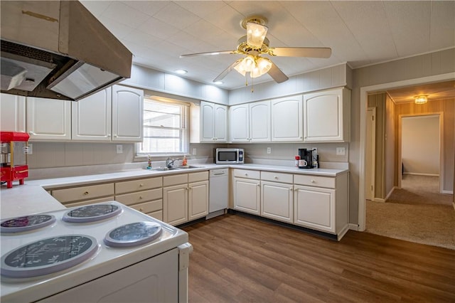 kitchen featuring under cabinet range hood, a sink, white cabinetry, white appliances, and light countertops