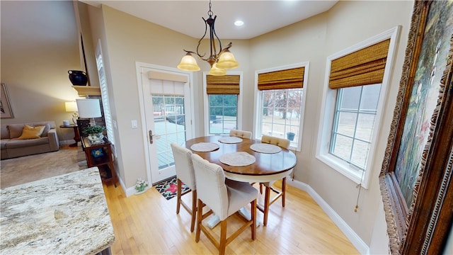 dining room featuring light hardwood / wood-style floors and a chandelier