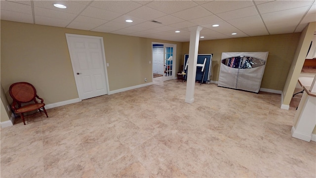 basement featuring a drop ceiling