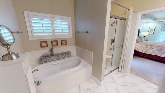 bathroom featuring shower with separate bathtub