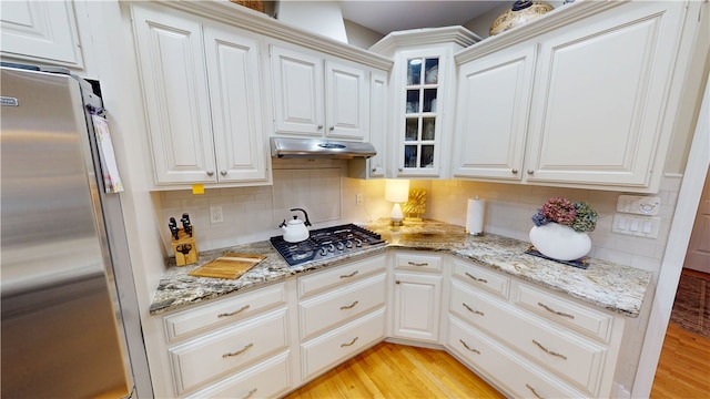 kitchen with white cabinetry, appliances with stainless steel finishes, and light hardwood / wood-style flooring