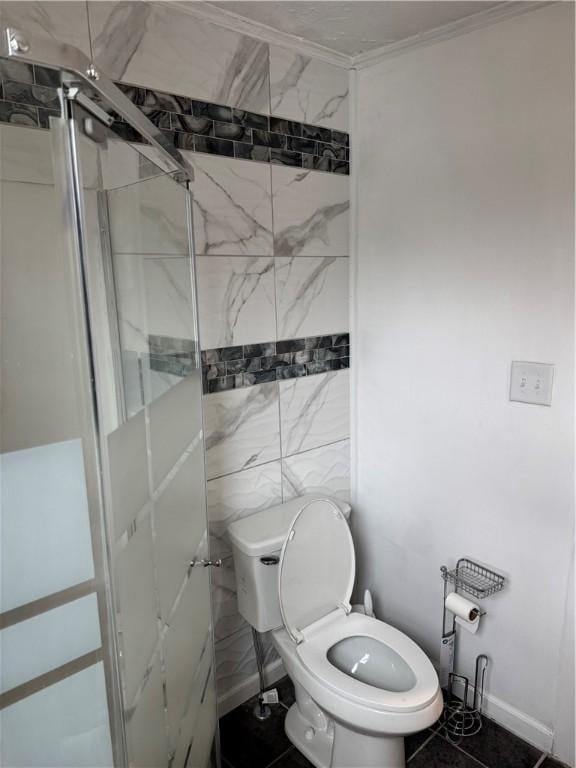 bathroom featuring a stall shower, crown molding, tile walls, and toilet