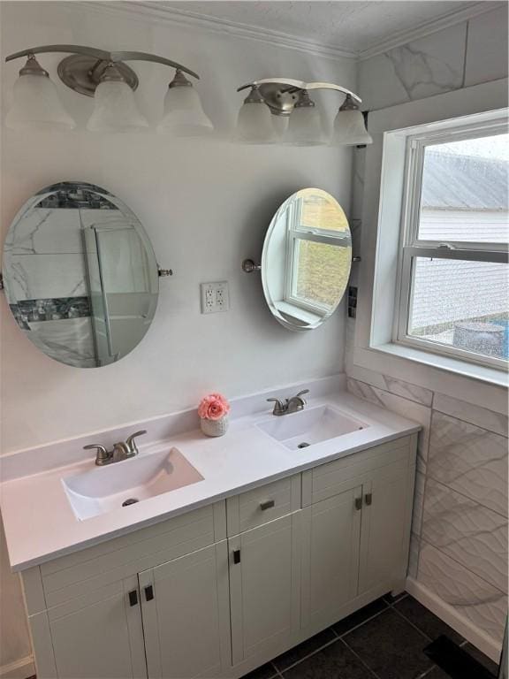 bathroom featuring double vanity, ornamental molding, a sink, and tile patterned floors