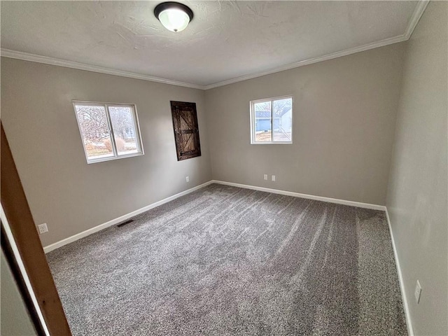 carpeted spare room featuring visible vents, crown molding, a textured ceiling, and baseboards