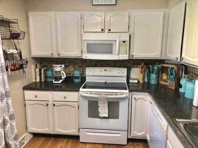 1213 Collins Dr, Effingham, IL 62401 - kitchen featuring white appliances, white cabinetry, and tasteful backsplash