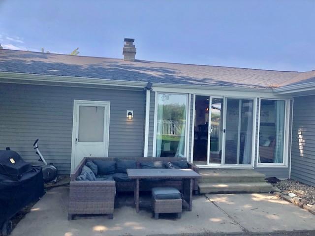 1213 Collins Dr, Effingham, IL 62401 - rear view of house featuring a patio area, entry steps, an outdoor living space, and a chimney