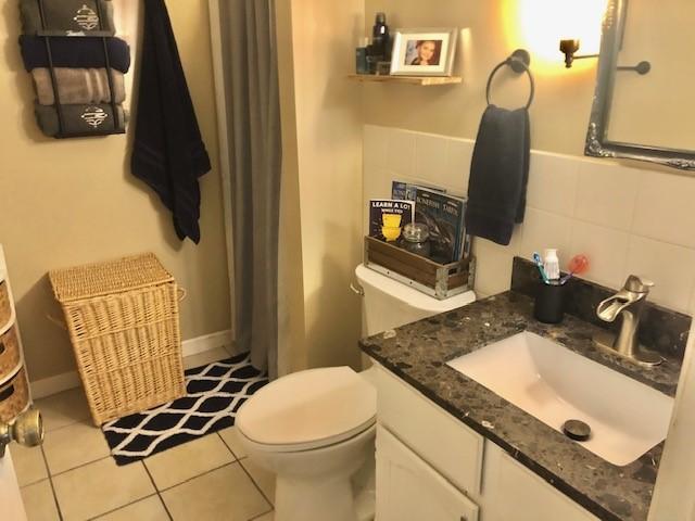 1213 Collins Dr, Effingham, IL 62401 - full bathroom with vanity, tile patterned flooring, a shower with shower curtain, and decorative backsplash
