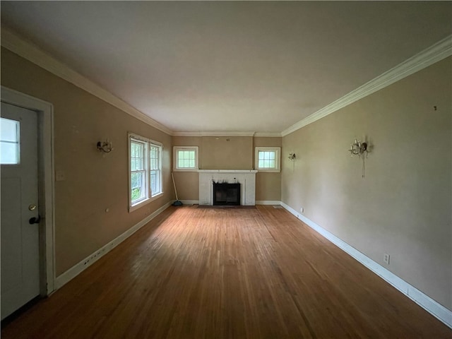 unfurnished living room with wood-type flooring and ornamental molding