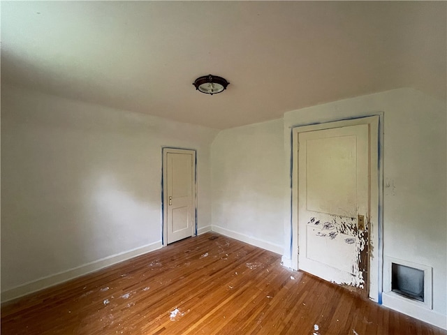 spare room with wood-type flooring