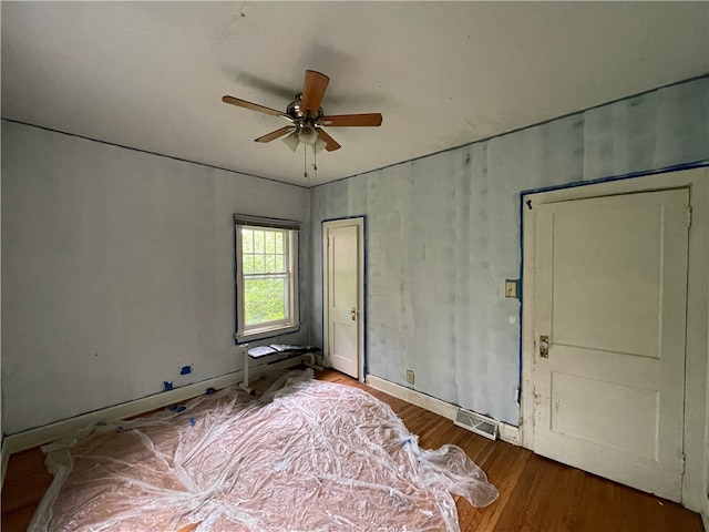 spare room featuring wood-type flooring and ceiling fan