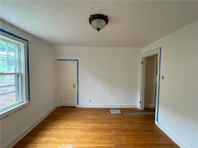 spare room with light hardwood / wood-style flooring and a wealth of natural light