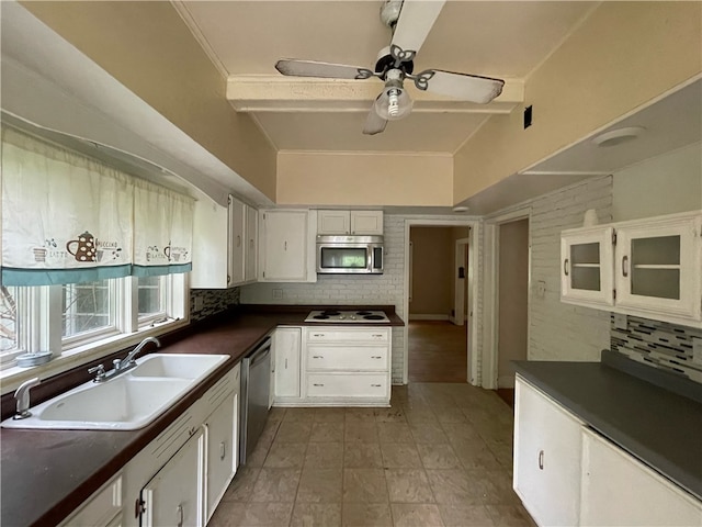 kitchen featuring decorative backsplash, sink, white cabinets, and appliances with stainless steel finishes