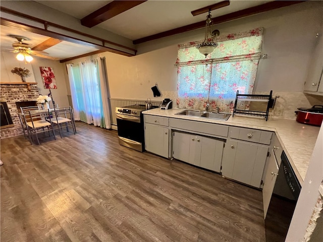 kitchen featuring ceiling fan, dishwasher, sink, decorative light fixtures, and electric stove