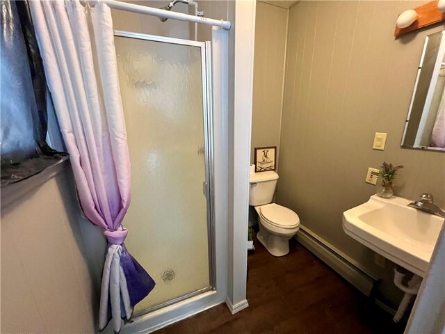 29 Homestead Dr, Newton, IL 62448 - full bathroom with a shower stall, baseboard heating, wood finished floors, toilet, and a sink