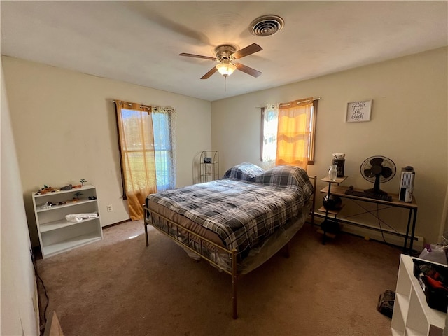 carpeted bedroom featuring baseboard heating and ceiling fan