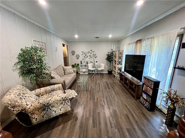 living room featuring dark hardwood / wood-style flooring and crown molding