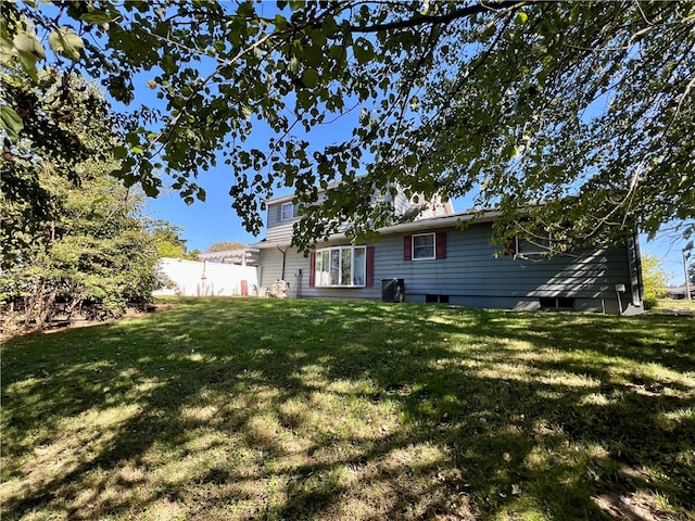 back of house with a lawn