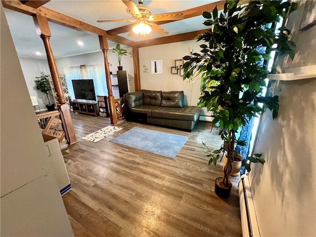 living room with wood-type flooring, baseboard heating, ceiling fan, and beam ceiling