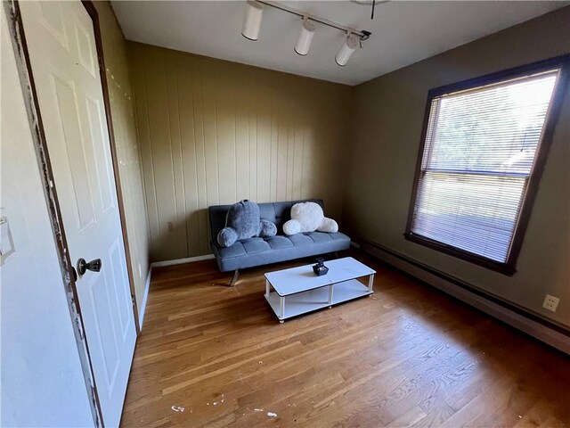 29 Homestead Dr, Newton, IL 62448 - living area featuring light wood-type flooring, a baseboard heating unit, baseboards, and rail lighting