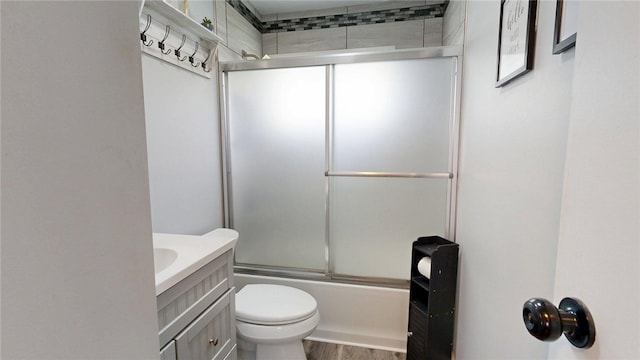 19 7th Dr, Decatur, IL 62521 - full bath with combined bath / shower with glass door, toilet, vanity, and wood finished floors