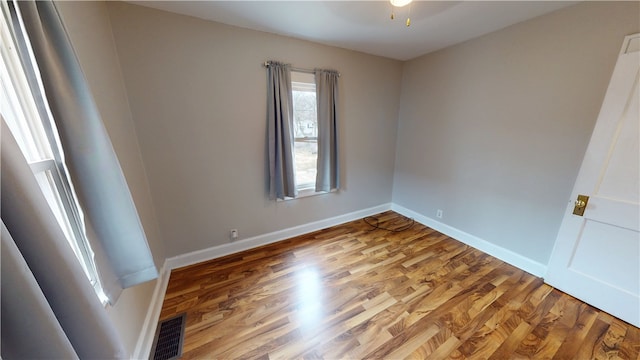 empty room with hardwood / wood-style floors