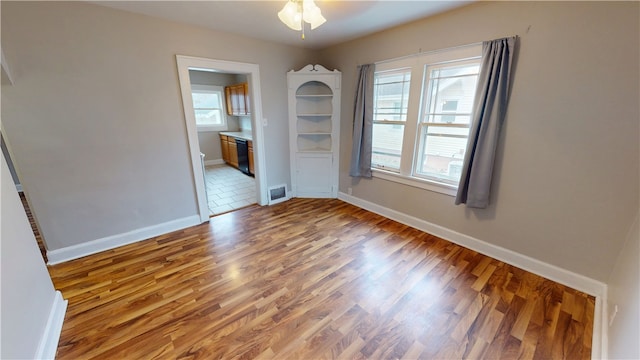 empty room featuring wood-type flooring and ceiling fan