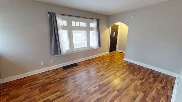 unfurnished room with hardwood / wood-style flooring