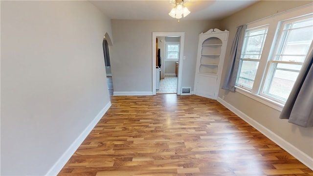 unfurnished dining area with ceiling fan and light hardwood / wood-style flooring